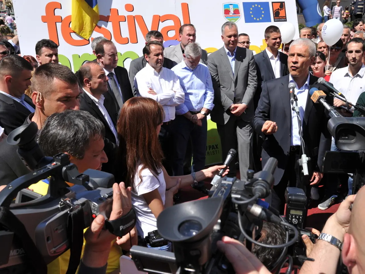 In this image I can see a group of people are standing on the road and are holding cameras in their...