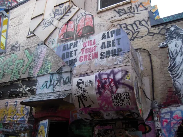 Here we can see graffiti and posters of people on the wall and we can see door.