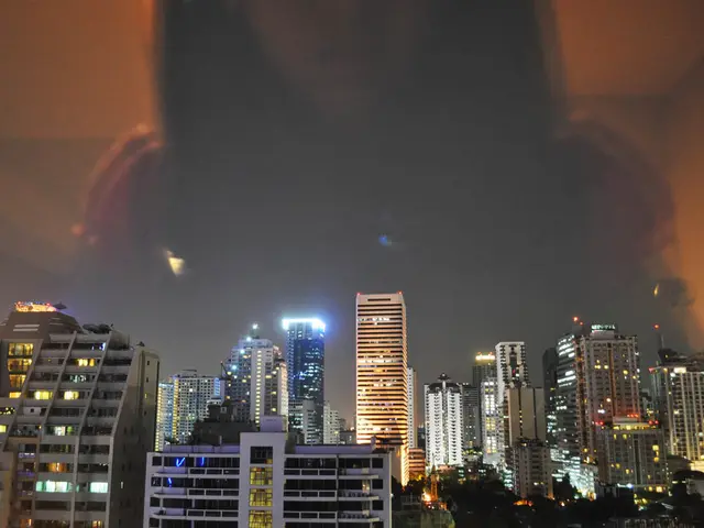 In this image there are buildings with lights.