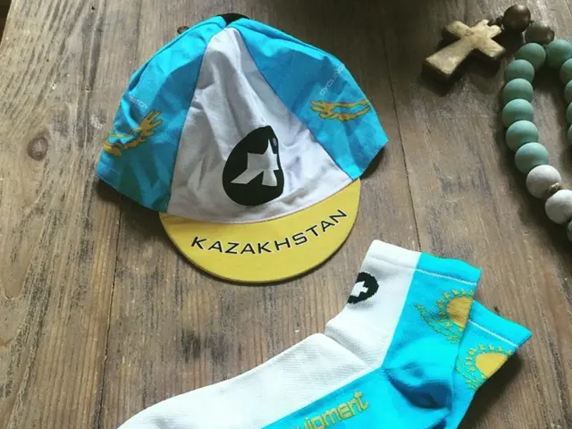 In this image we can see socks, cap and a chain on the table.